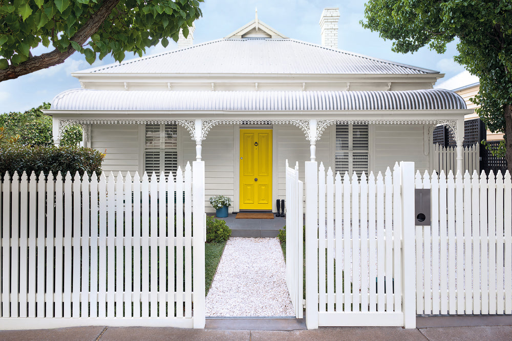 White house with bright yellow door