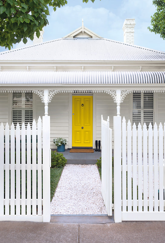 White house with bright yellow door